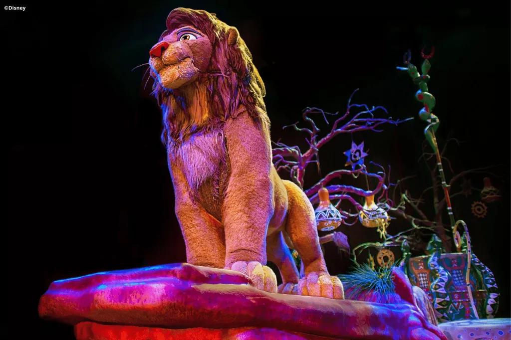 Festival of the Lion King A Simba animatronic on a float decorated to look like Pride Rock