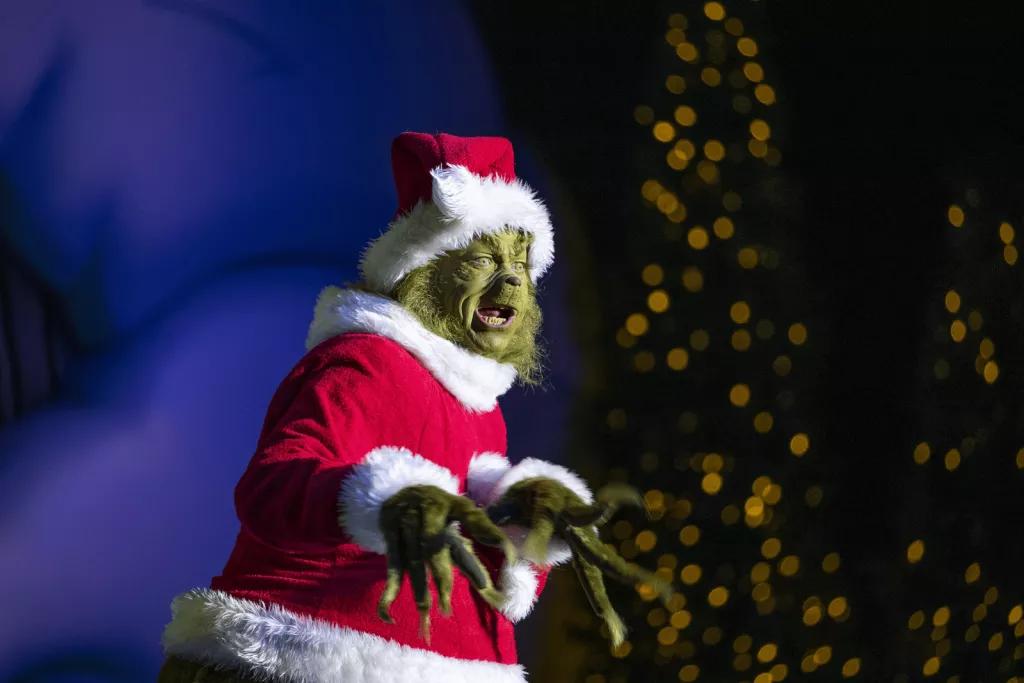 Grinchmas The Grinch dressed as Father Christmas standing on a stage