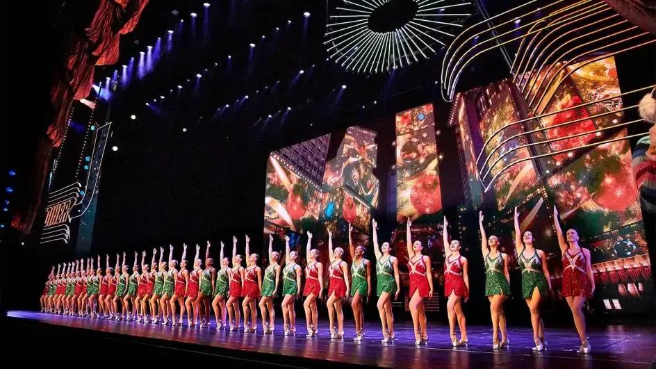 The Radio City Rockettes A line of dancers in sparkly leotards on stage facing the audience