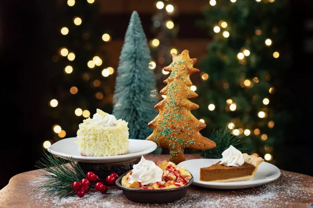Food at SeaWorld's Christmas Celebration Plates of food including pumpkin pie and an iced cake infront of Christmas trees and lights