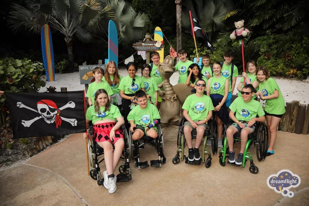 Dreamflight Visit to Typhoon Lagoon A group of children, some in wheelchairs, wearing bright green tshirts at Typhoon Lagoon