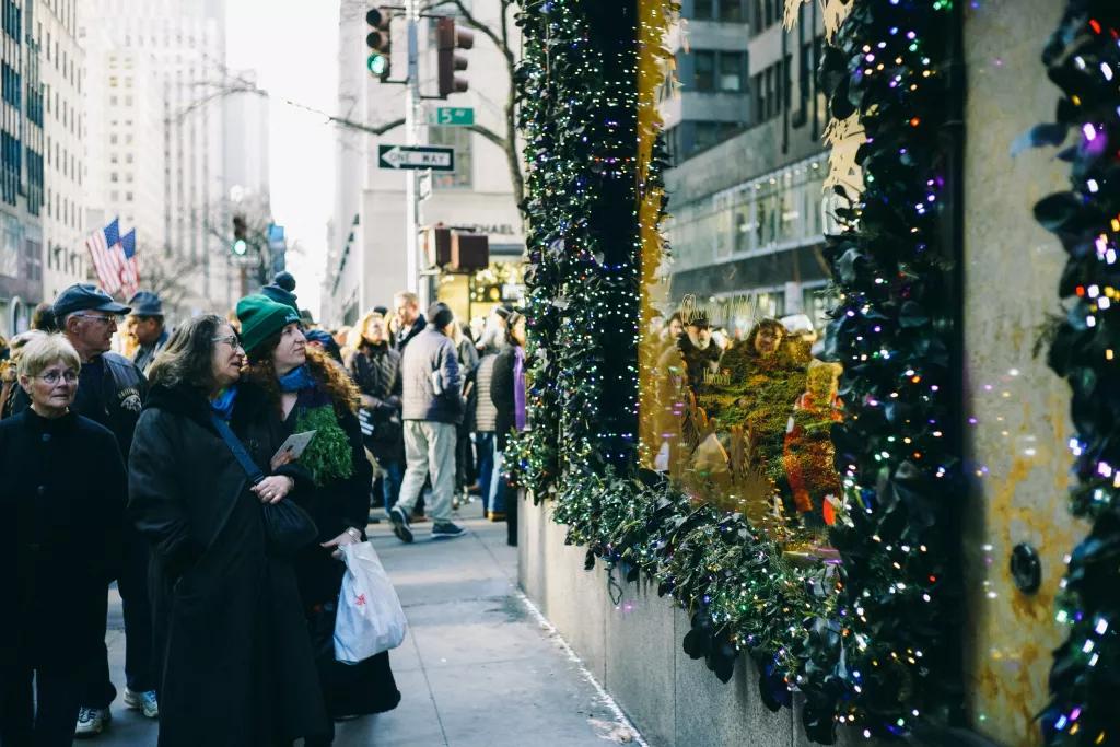 Fifth Avenue at Christmas People walking along Fifth Avenue looking in shop windows decorated for Christmas