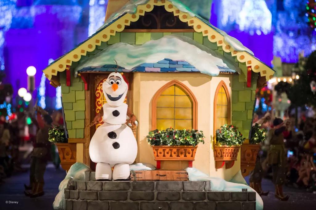 Mickey's Very Merry Christmas Party Olaf the snowman on a parade float designed to look like a house