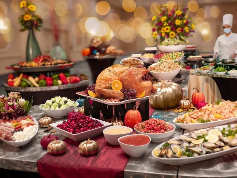 Thanksgiving Buffet A table full of Thanksgiving foods, including turkey, cranberry sauce, stuffing and shrimp