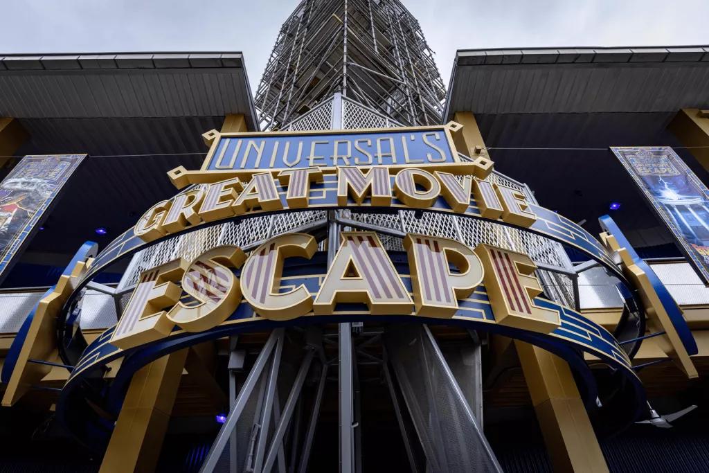 Universal's Great Movie Escape An art deco style sign on the outside of a building, which says Universal's Great Movie Escape