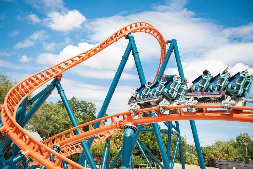 Ice Breaker at SeaWorld Orlando A ride vehicle on a bright orange and blue twisting roller coaster track
