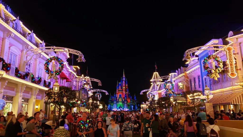 Mickey's Very Merry Christmas Party Main Street USA at Magic Kingdom decorated for Christmas with wreaths and lights on Cinderella Castle