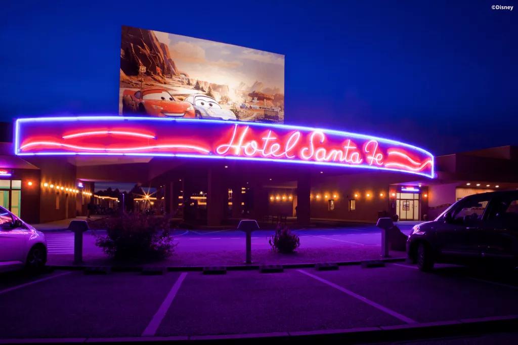 Hotel Santa Fe The exterior of the Hotel Santa Fe with neon letters and a billboard featuring characters from Cars