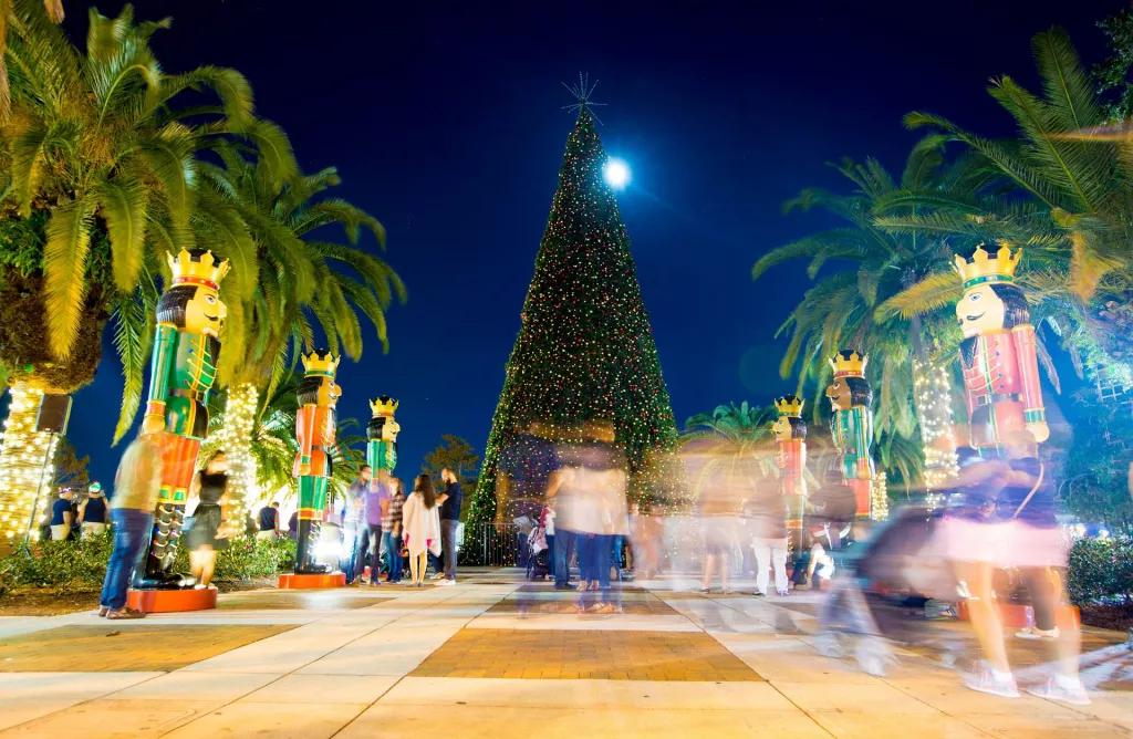 Lake Eola Christmas Tree People standing looking up at a large Christmas tree on a path lined with giant nutcrackers