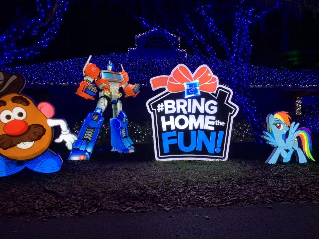 Night of a Million Lights Large lit up decorations of children's toys and a large present saying "Bring Home The Fun"