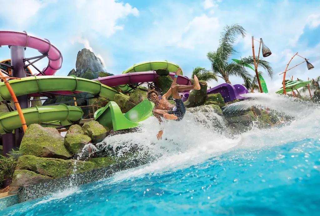 Ohno and Ohyah waterslides at Volcano Bay A man coming out of a waterslide about to land in a pool