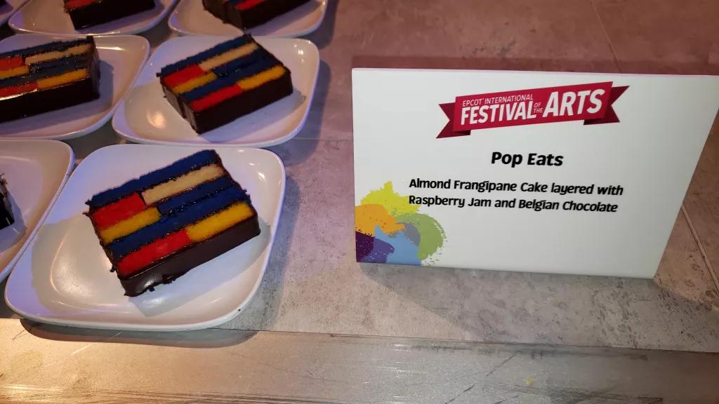 Food at Festival of the Arts A row of cakes made of multicoloured layers on a table
