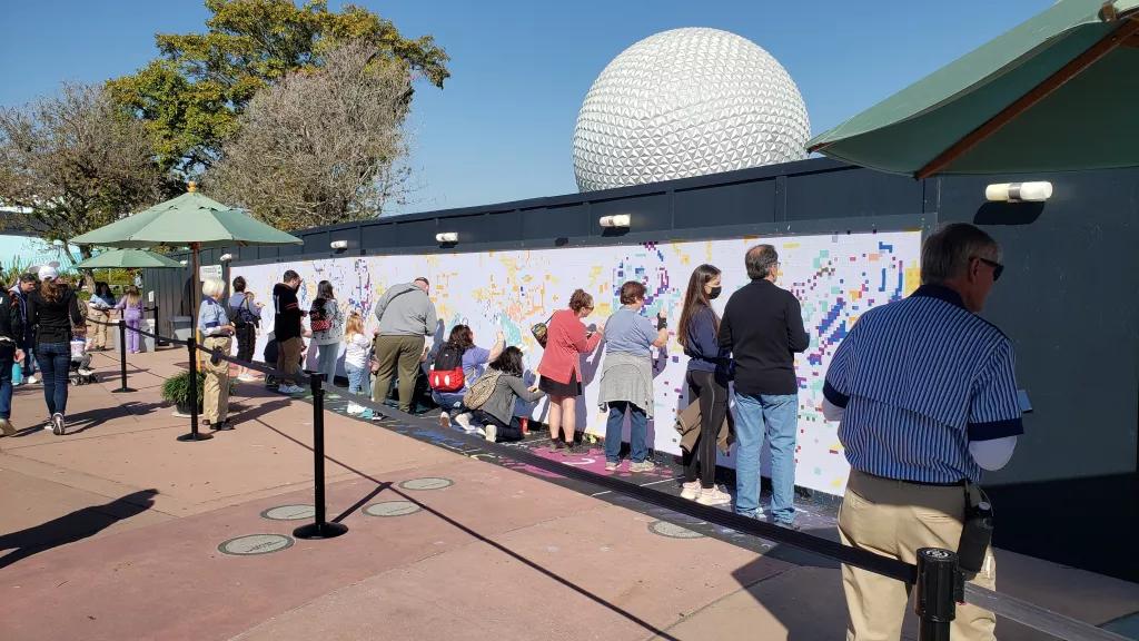 The Expression Section A group of people painting a large paint by numbers mural on a wall