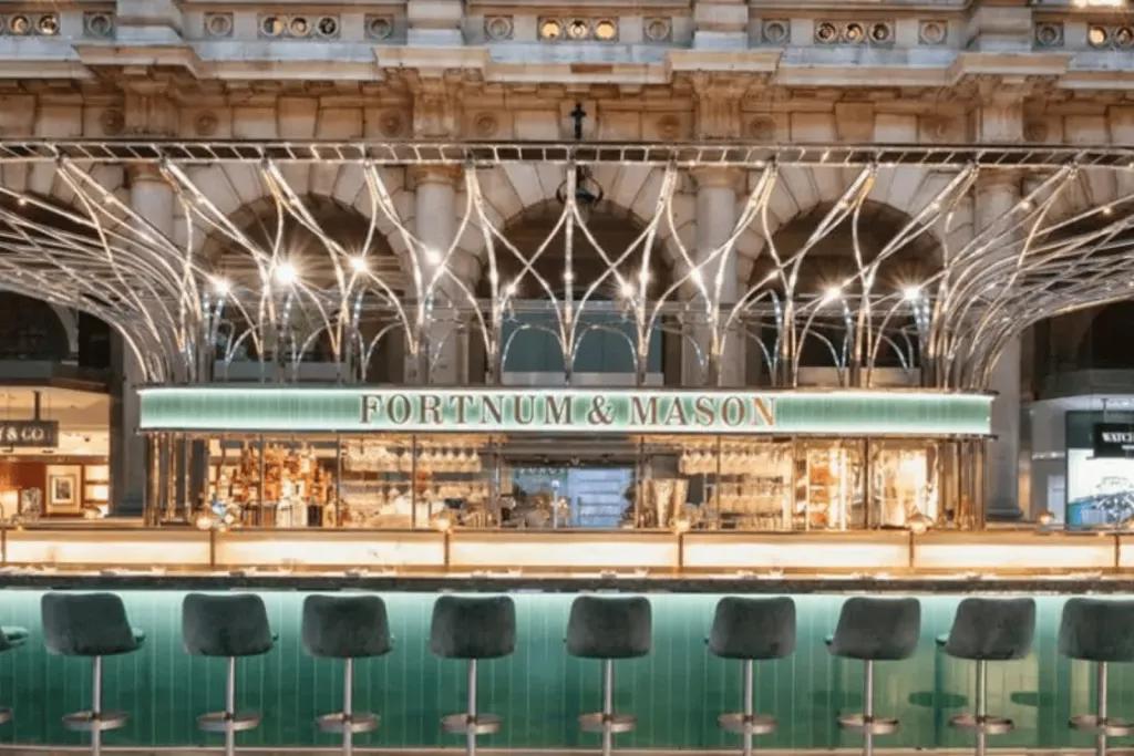 Fortnum and Mason Bar A jewel coloured bar lit up with gold accents featuring the name Fortum and Masons