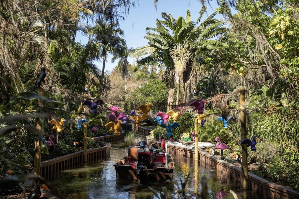 Pirate River Quest A boat sailing through a waterway lined by tall trees and greenery, with LEGO birds overhead