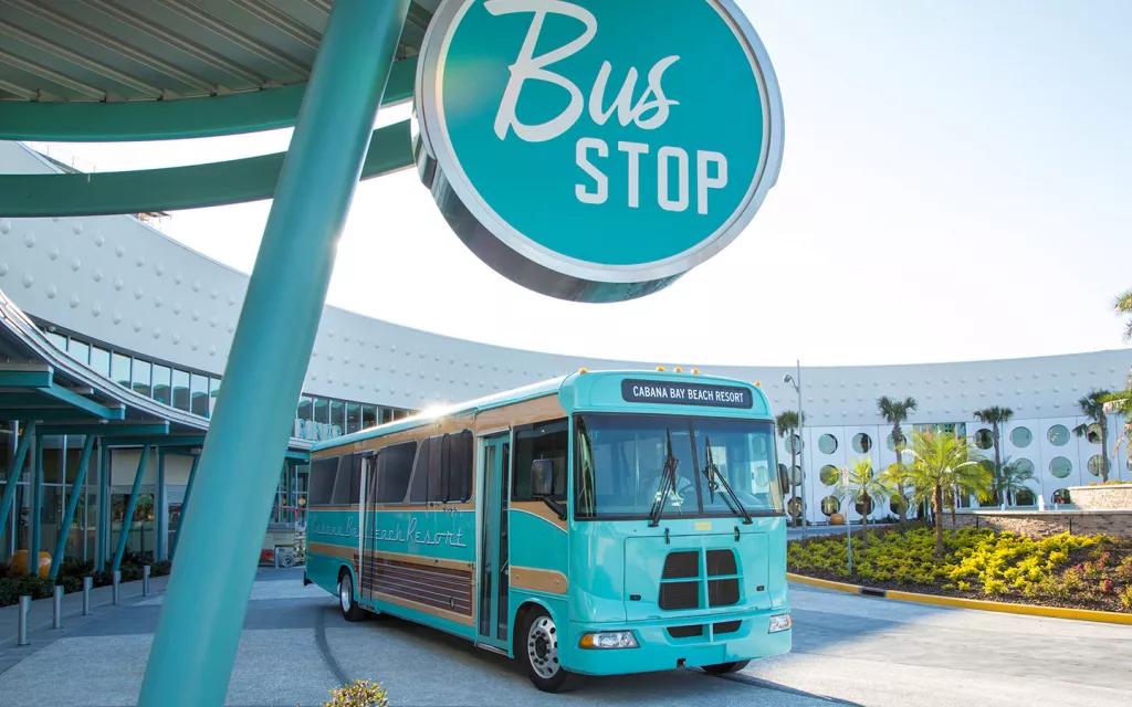 Universal Resort Hotel Buses A bright blue bus waiting next to a Bus Stop sign
