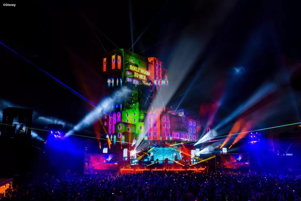 Music Performances at Disneyland Paris Pride Tower of Terror at night lit up with rainbow colours and spotlights