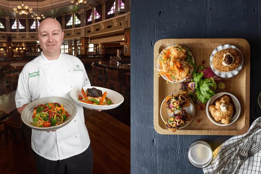 Chef Mark O'Neill Chef Mark O'Neill holding two dishes and a 'Board of Beauty' with multiple appetisers on a tray