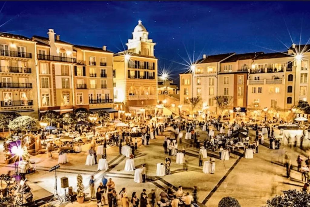 Harbor Nights at Portofino Bay Hotel An aerial view of a large group of people standing around tables at Portofino Bay Hotel at night