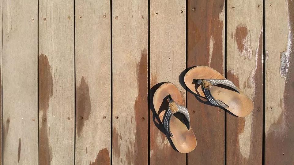 Flip Flops A pair of flip flops on a wet wooden deck