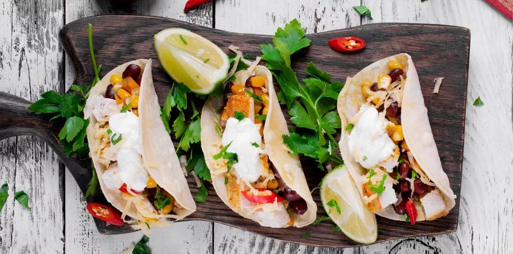Kavas Tacos Three soft tacos filled with chicken, beans, corn and cheese