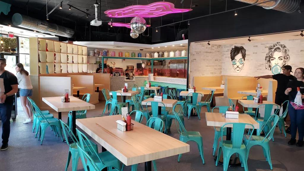 Interior of JoJo's ShakeBar The interior of a diner style restaurant with light wooden tables and teal chairs