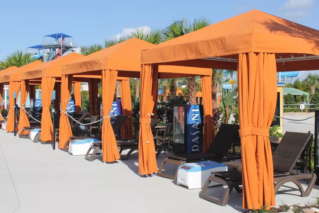 Island H2O Cabanas A row of orange cabanas with deck chairs, coolers and drinks machines inside