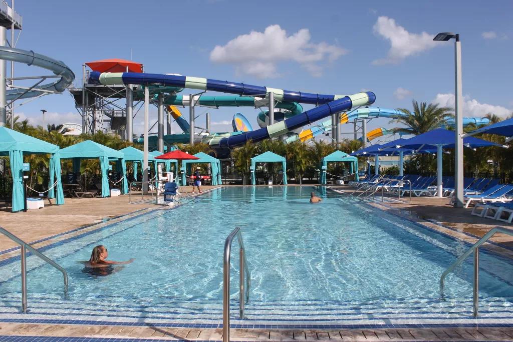 Private Domain A rectangular pool adults-only pool with large water slides in the background