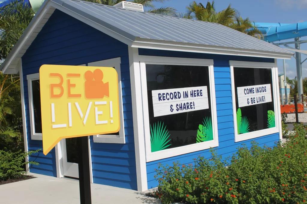 Be Live! A shack with two large windows behind a sign that reads 'Be Live'