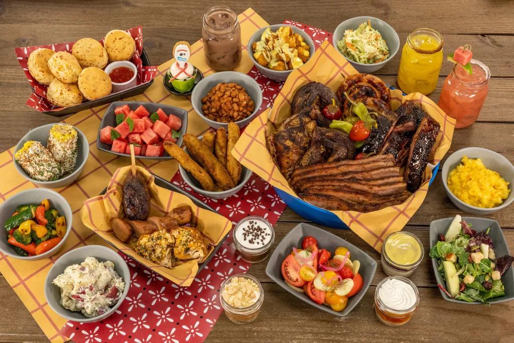 Food at Roundup Rodeo BBQ A birds eye view of a plate full of barbecue food including a plate of meats, salads, corn on the cob and desserts