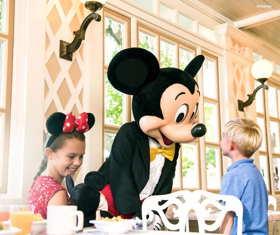 Character Dining A photo of Mickey Mouse with guests at character dining