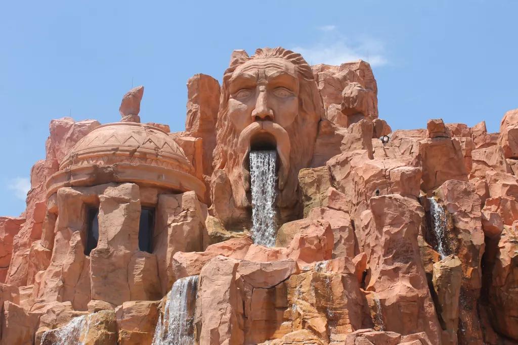 Mythos Restaurant at Universal Orlando A rock formation carved to look like a face with a waterfall coming out of the open mouth