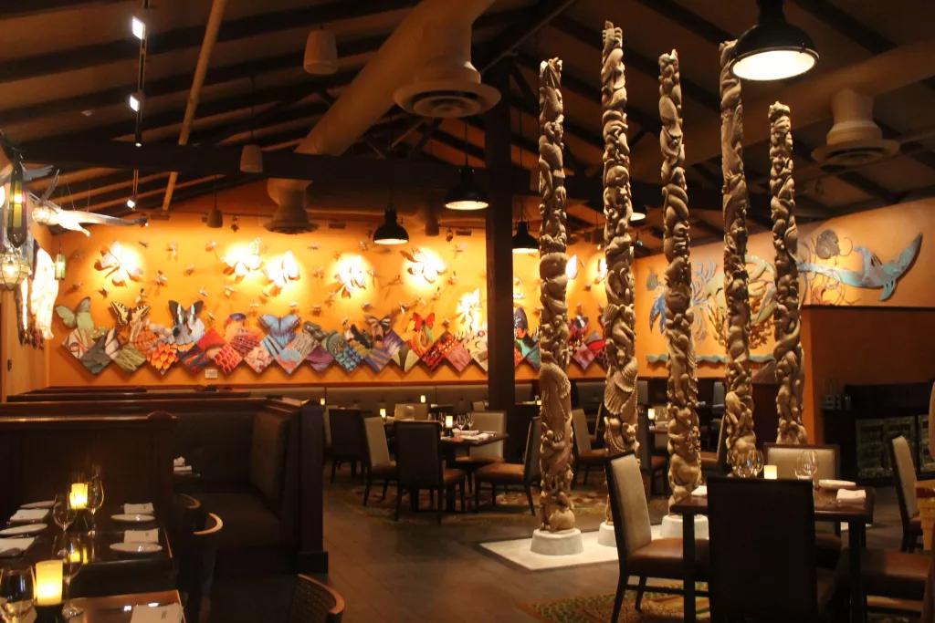 Tiffins at Animal Kingdom Theme Park An empty restaurant with butterflies and animal prints on the wall and pillars designed to look like they are made of shells