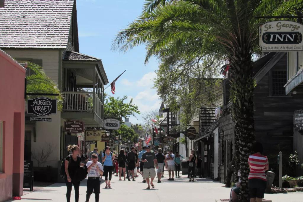 St George Street in St Augustine A pedestrian street full of people, lined with palm trees and shops