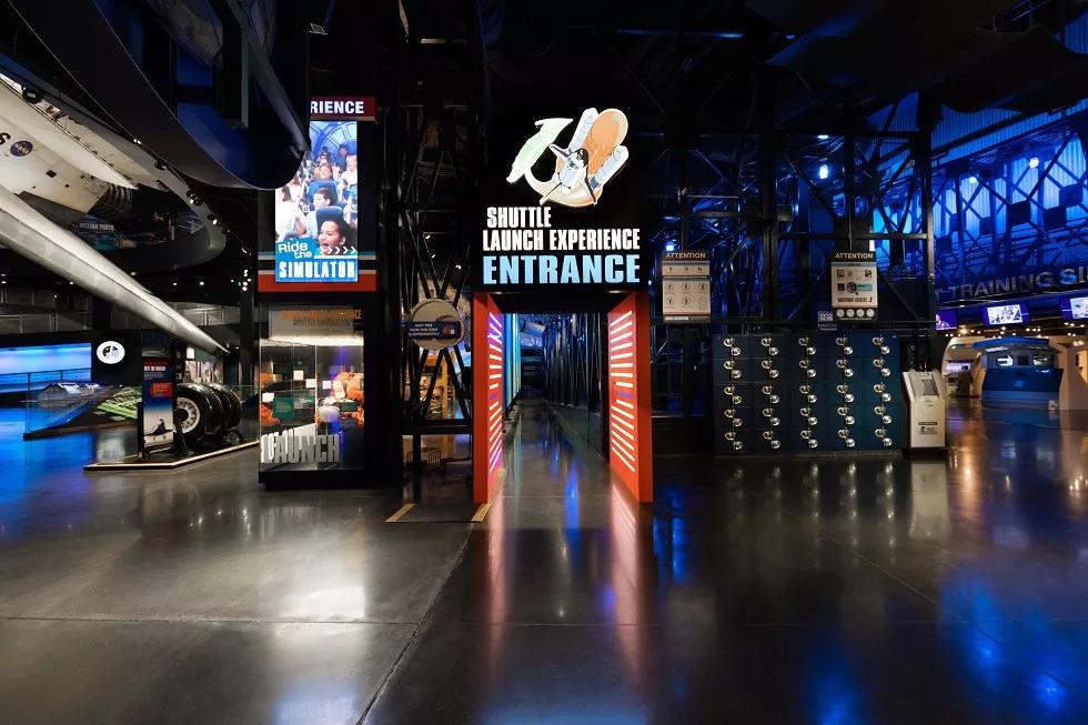 Space Launch Experience at Kennedy Space Center The entrance to the Space Launch Experience featuring a lit up sign above a doorway