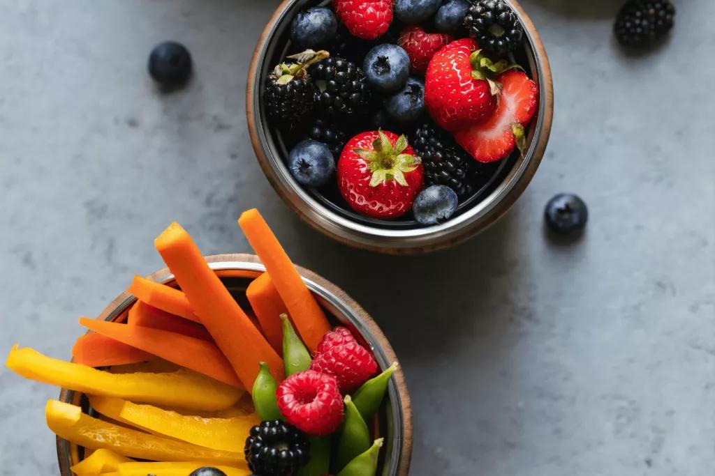 Bring Your Own Snacks A bird's eye view of a pot of berries and a pot of cut up vegetables