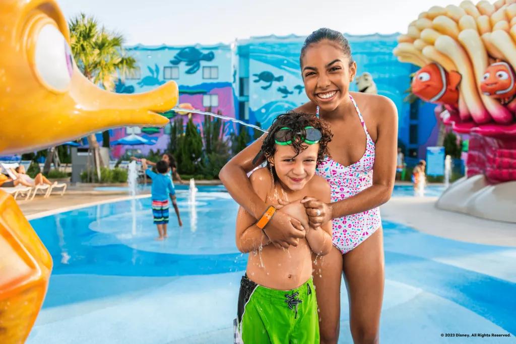 Disney's Art of Animation Resort A young boy and girl standing in a splash pad themed after Finding Nemo