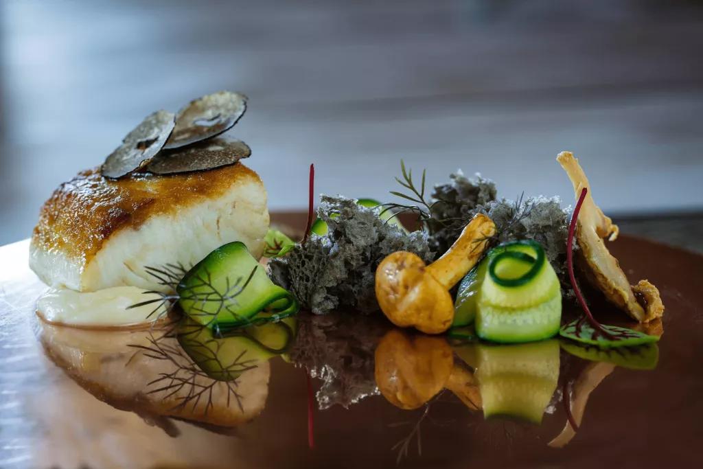 Normans A plate of grilled fish with vegetables and herbs