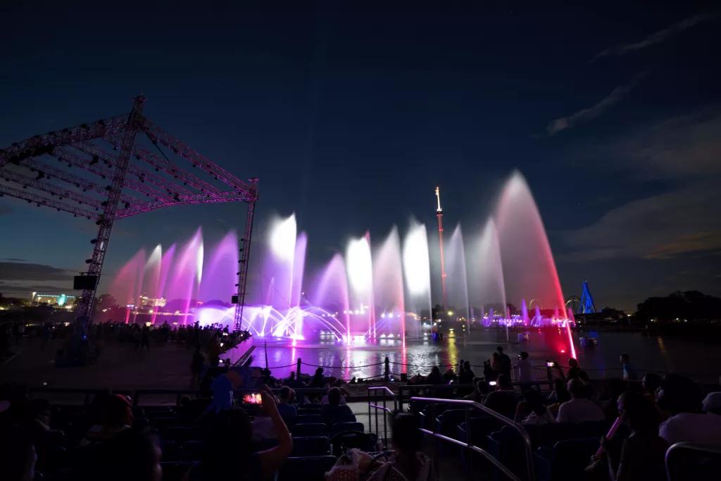 Ignite Fireworks Fountains over a lake lit up at night, surrounded by spectators