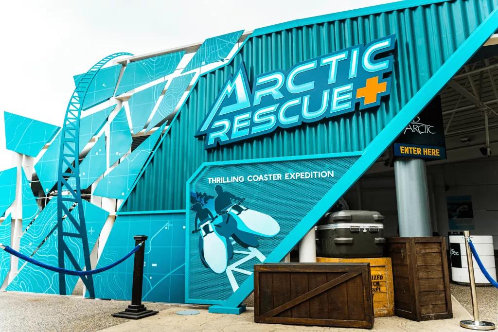 Arctic Rescue The exterior of a building designed to look like a teal shipping container with Arctic Rescue written on the side