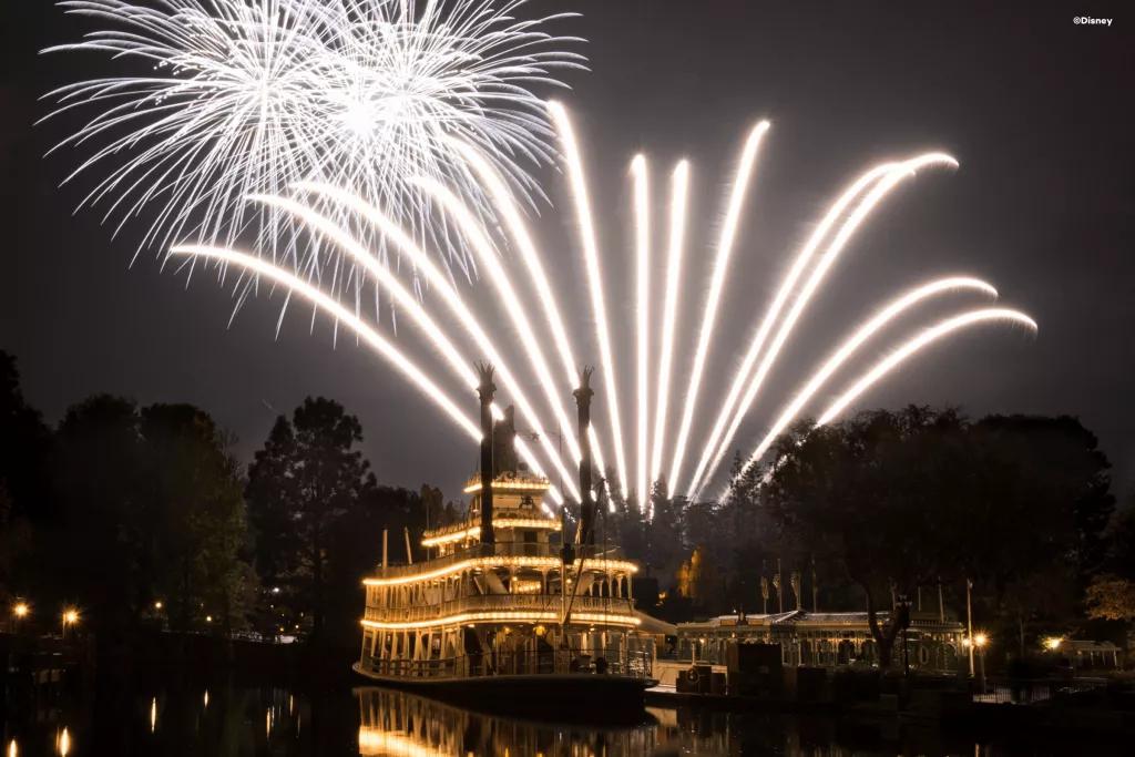 Mark Twain Riverboat A large riverboat lit up at night with fireworks in the background