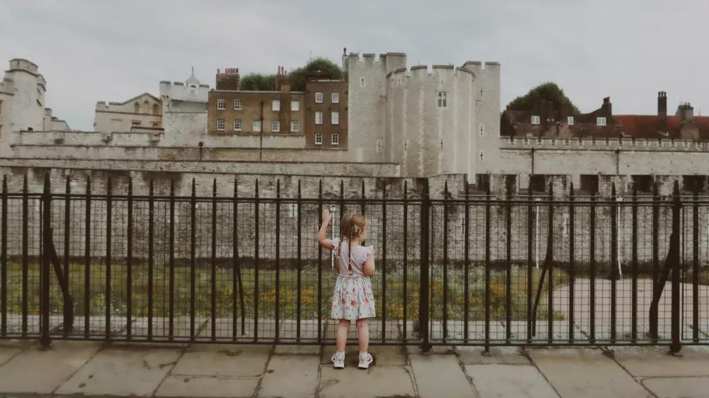 Mädchen am Zaun vor dem Tower of London Ein kleines Mädchen steht an einem Zaun vor dem Tower of London