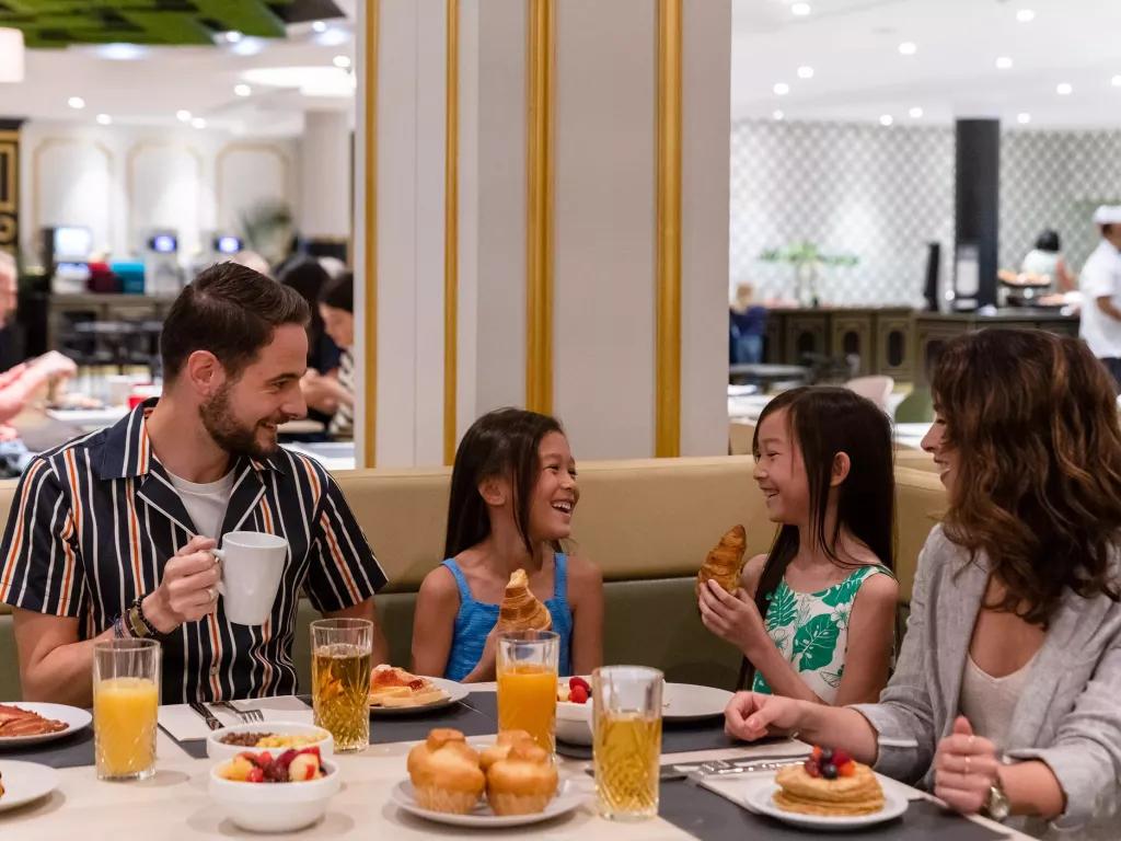 Breakfast at Dream Castle Hotel A family of two adults and two children sat at a restaurant table eating breakfast