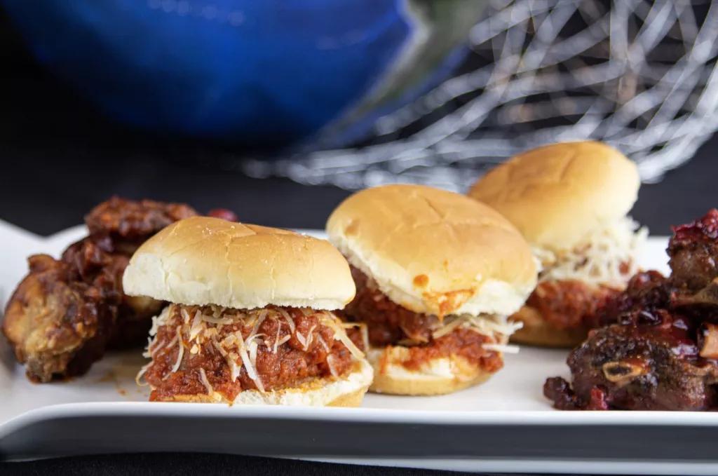 Chat with an Astronaut Fall Bites A plate of small meatball sliders, chicken wings and pork 'wings'