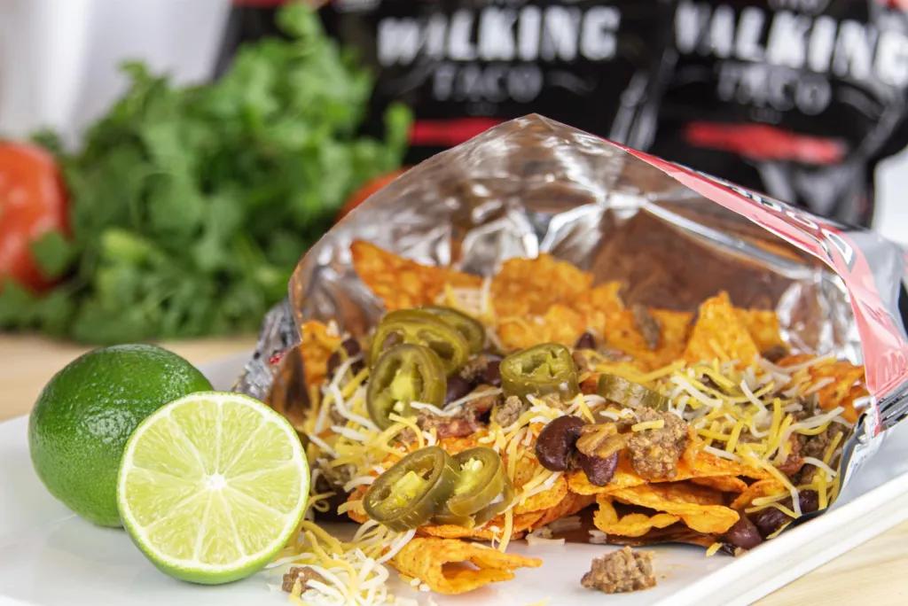 Walking Taco with Chili, Cheese and Jalapeño A crisp packet full of nachos topped with chilli, cheese and jalapenos