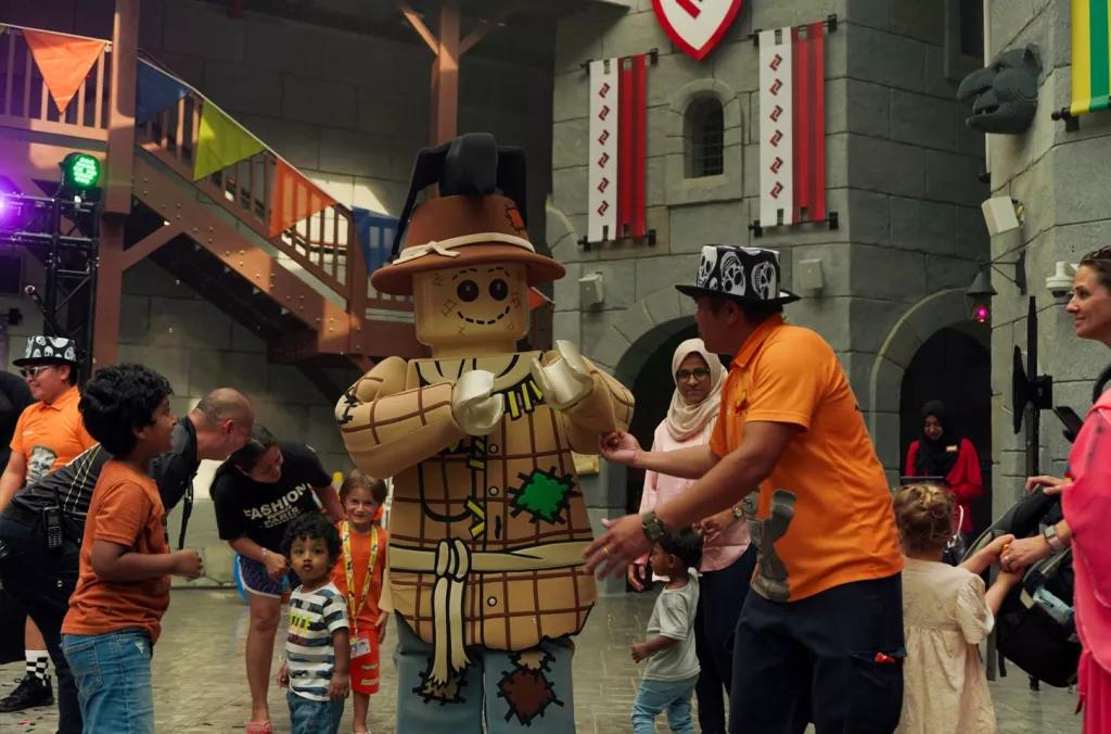 Monster Party at LEGOLAND Dubai A Lego scarecrow dancing with children and their parents