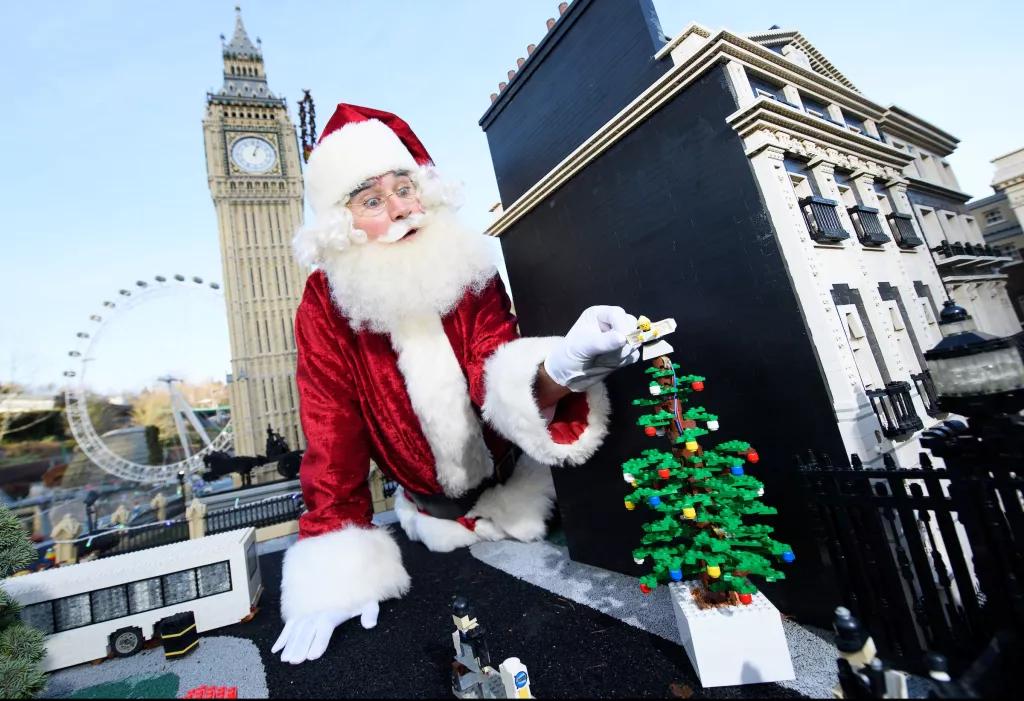 Father Christmas at LEGOLAND Windsor Father Christmas adding a Lego Christmas tree to a Lego model of London