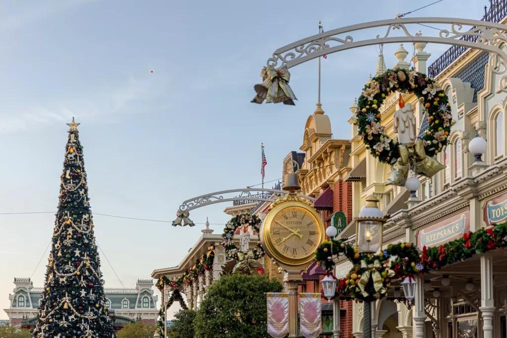Main Street U.S.A. at Christmas Main Street decorated with wreathes and ribbons leading to a giant Christmas tree