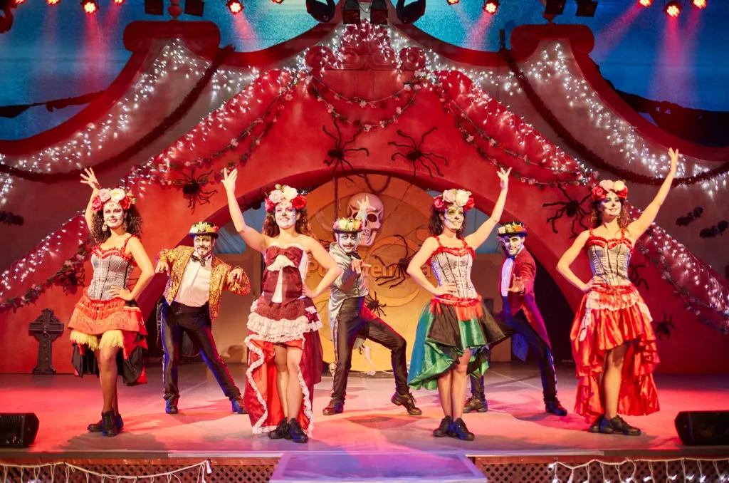 Halloween Entertainment at PortAventura Performers posing on stage wearing Mexican costumes and Day of the Dead face paint