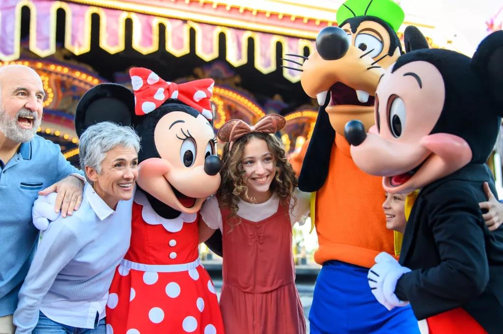 Walt Disney World Resort in Florida A family meeting Mickey, Minnie and Goofy in front of the carousel